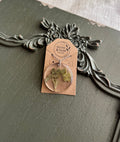 Round clover resin pendant necklace on silver chain displayed on Stone & Stem Jewelry card