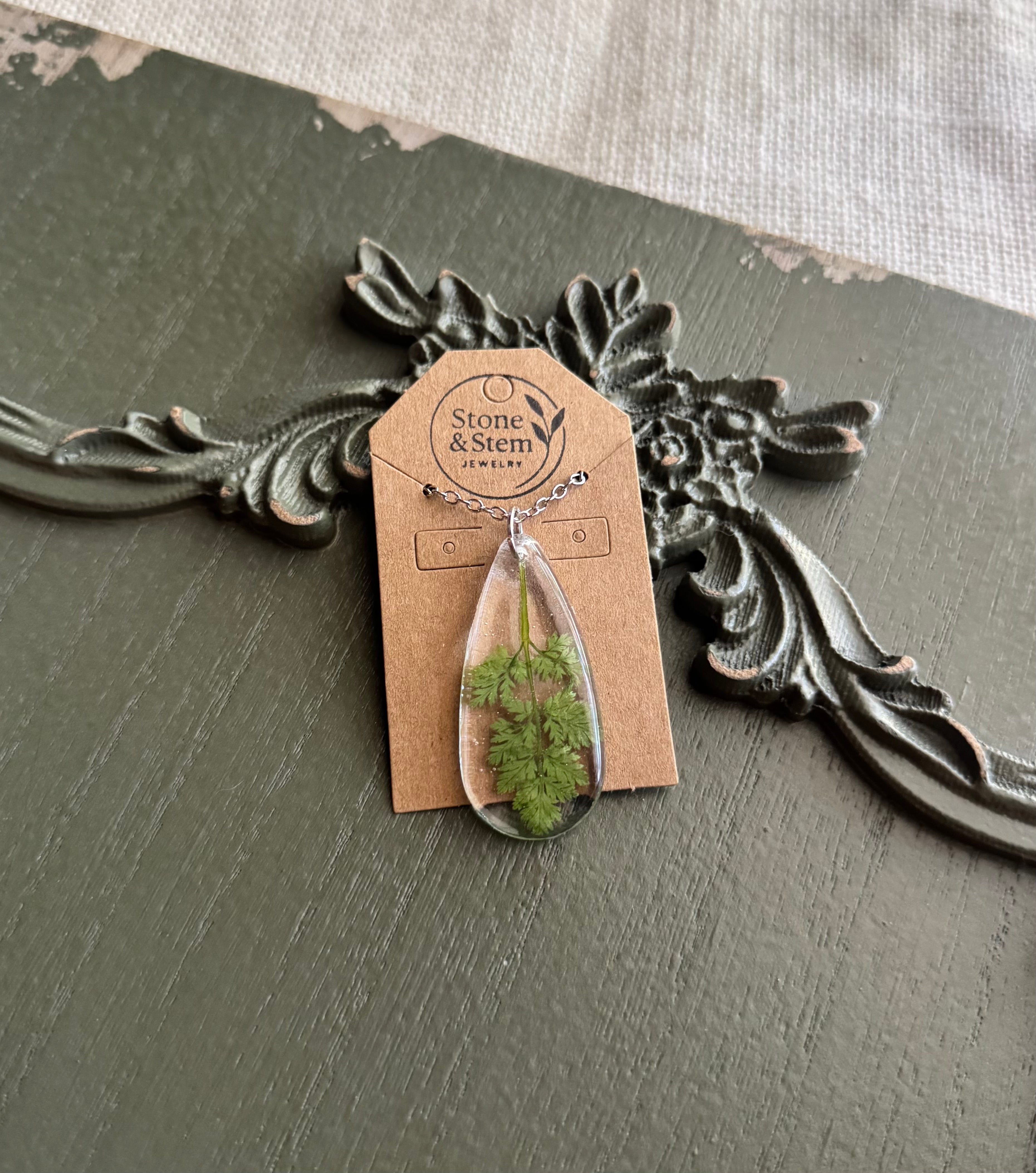 Queen Anne's Lace leaf teardrop resin pendant necklace on silver-tone chain displayed on Stone & Stem Jewelry card