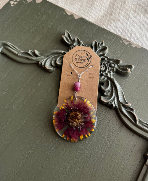 Blanket flower preserved in clear round resin pendant necklace with pink stone bead on silver-tone chain, displayed on Stone & Stem Jewelry card